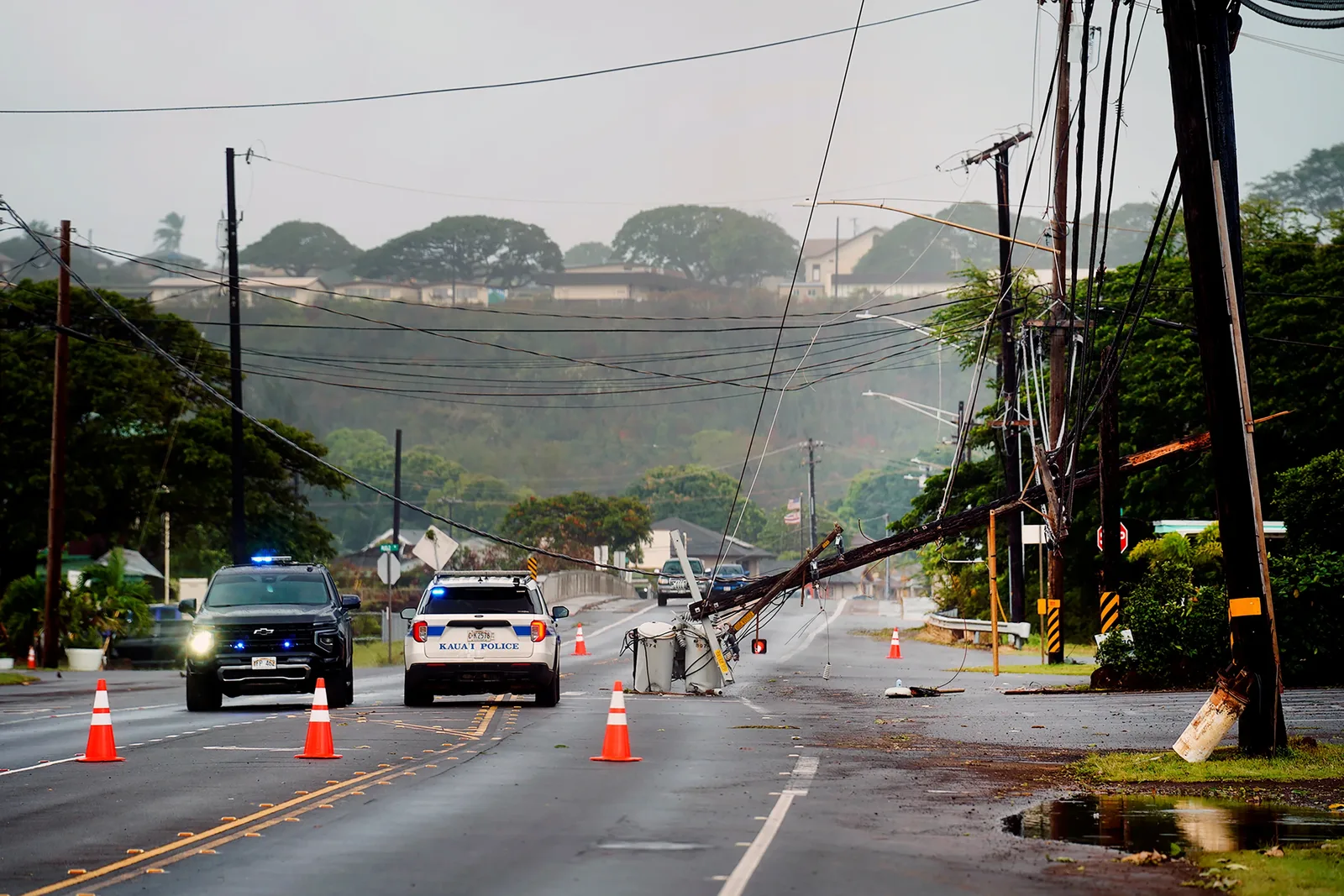 Downed utility pole and Kauaʻi Police cruiser after Hurricane Lowell