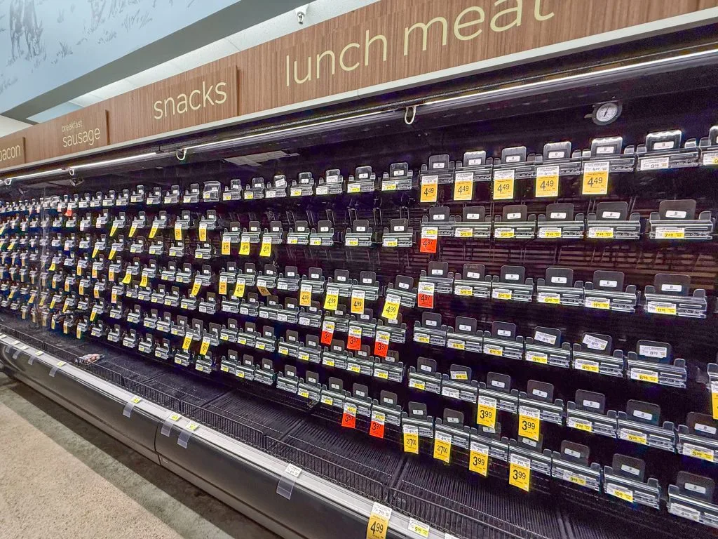 Empty supermarket cold case after Hurricane Lowell