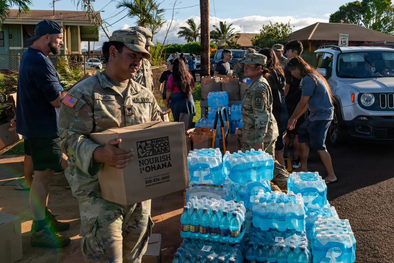Military and community volunteers distributing Hawaii Foodbank boxes and bottled water